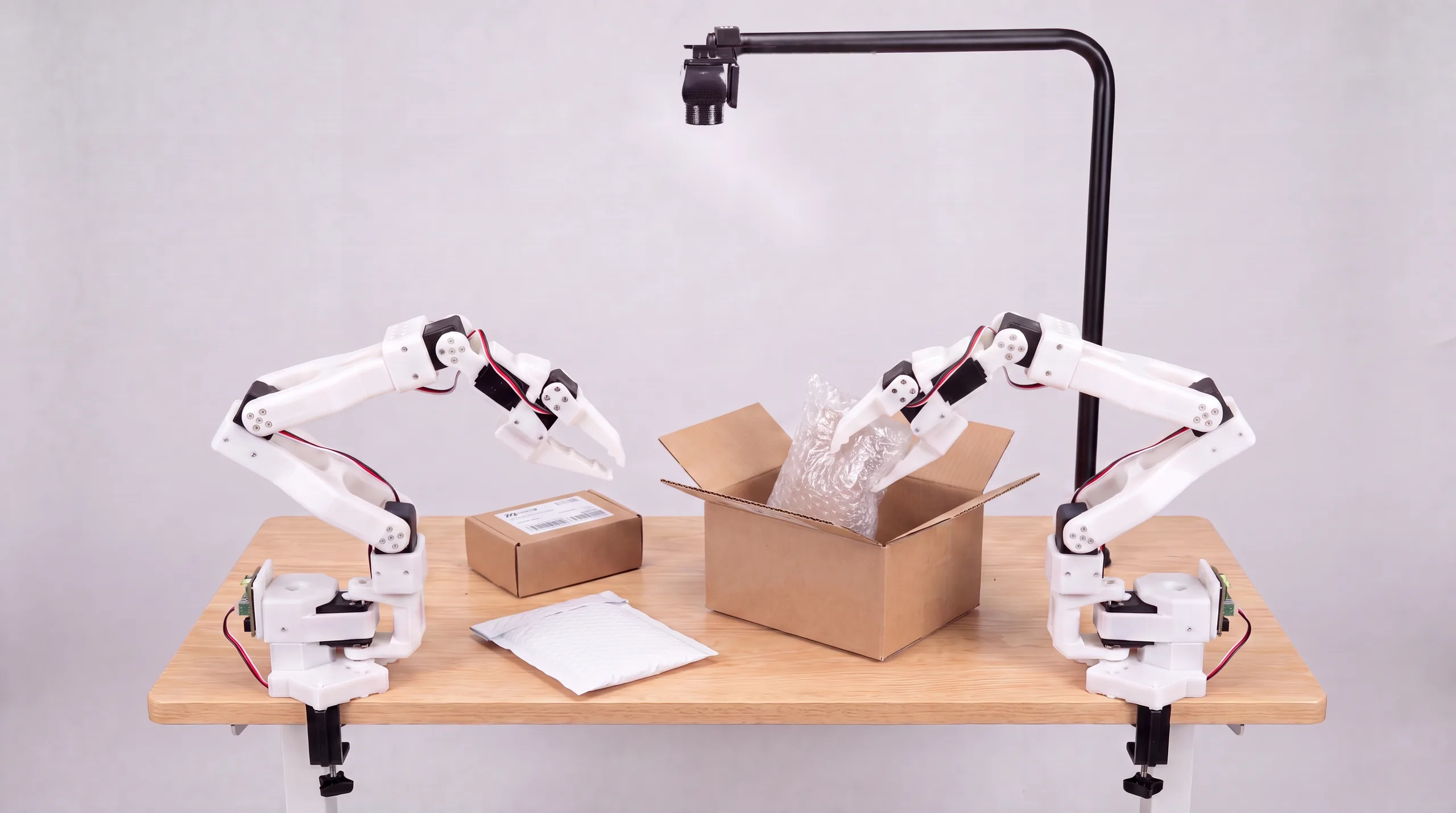 Robot arm placing bubble wrap into an open shipping carton